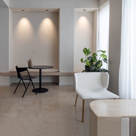 Designer armchair with wooden legs Wrapp by Viccarbe in a living room|Aiure